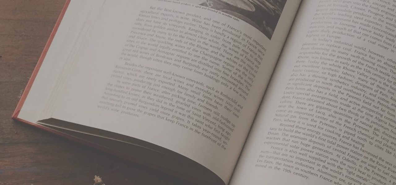 Close up of open book on wooden desk